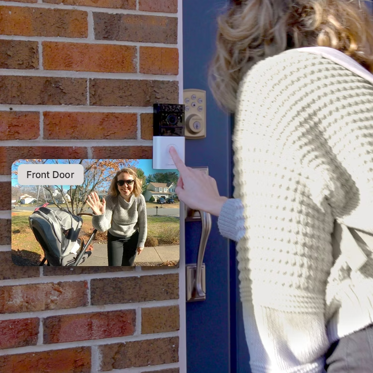 woman checking video doorbell