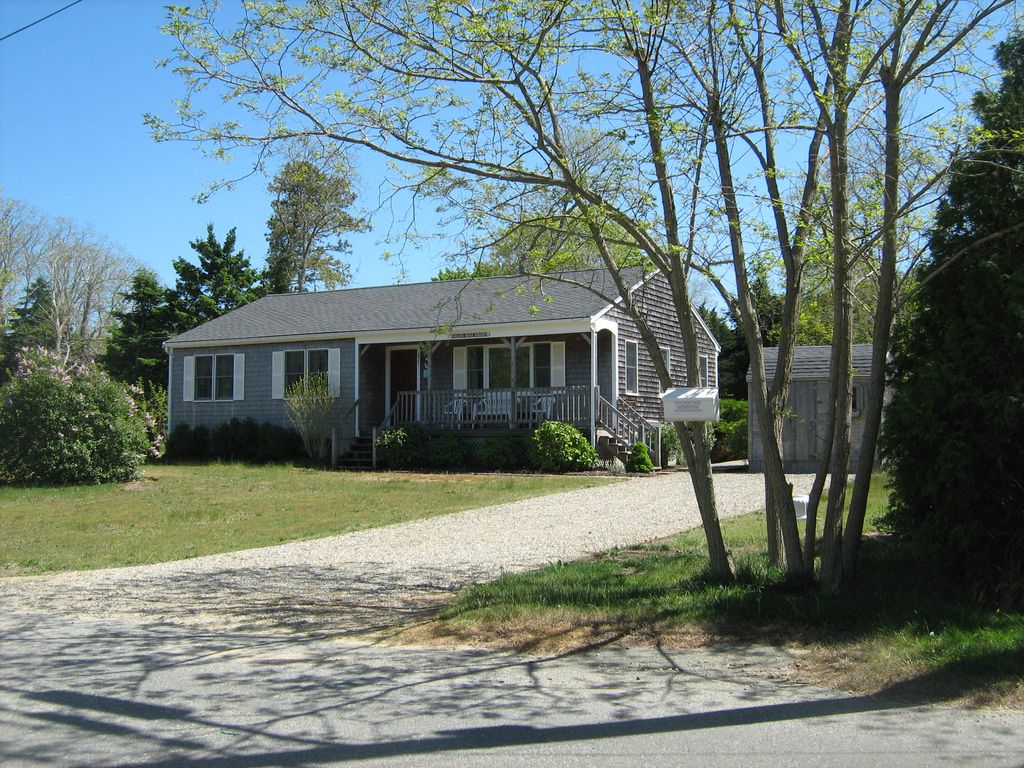 cape cod style ranch home and shed