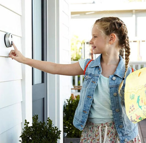 girl pushing doorbell